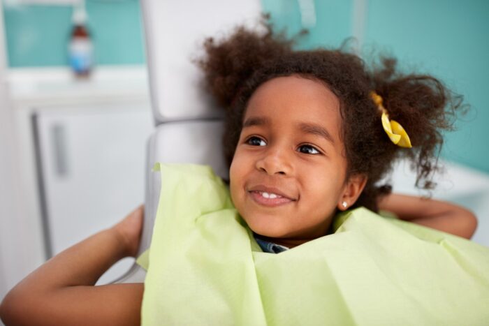Portrait of satisfied child in dental chair after successful dental treatment pediatric dentistry dentist in Oxnard California