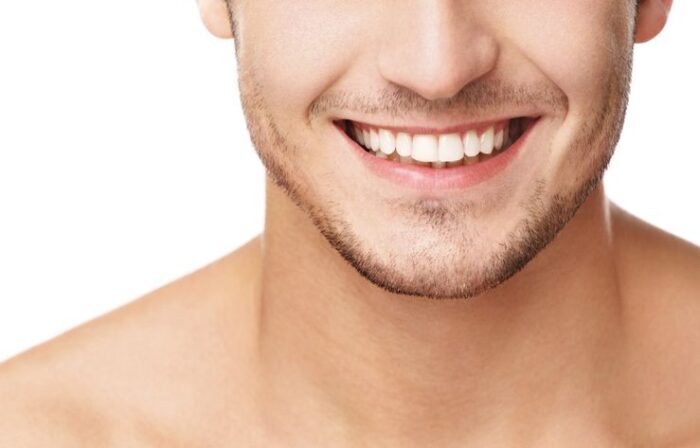 cropped image of a man with a straight white smile on a white background teeth whitening cosmetic dentistry dentist in Oxnard California